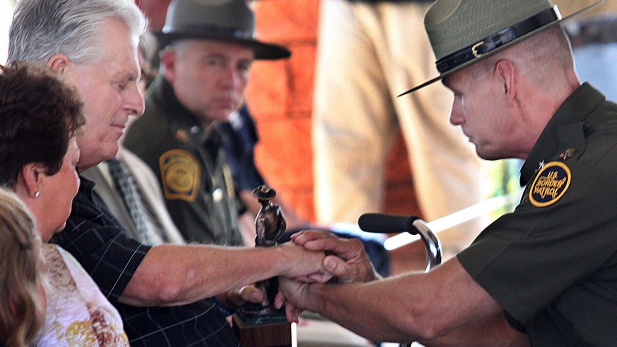 Kent Terry Sr., left, father of slain Border Patrol Agent Brian Terry, with Richard "Rick" Barlow, chief agent of the Tucson sector, during a ceremony in which the Border Patrol station in Naco, Ariz., was named after his son in 2012.