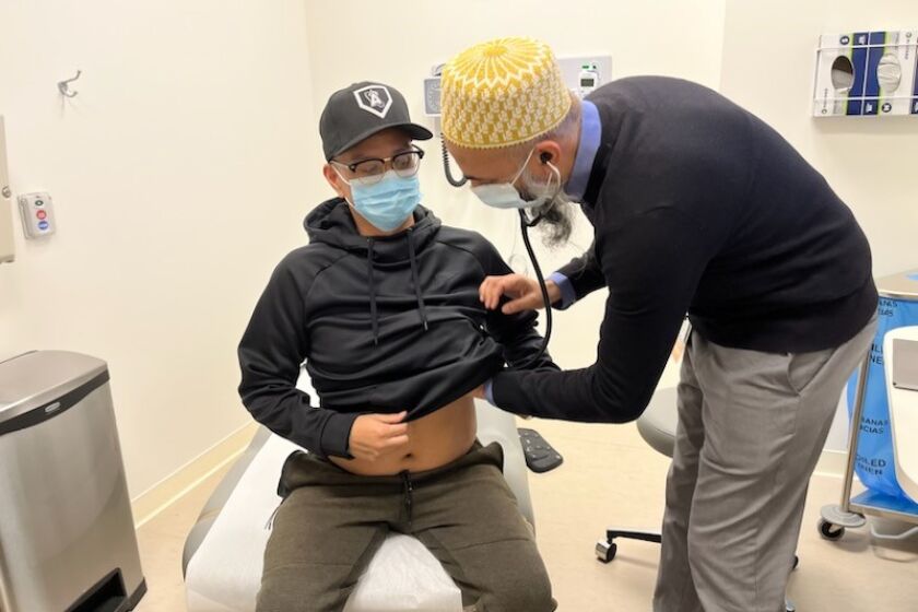 Giancarlo Santos gets a check-up from Dr. Akil Merchant at Cedars-Sinai Medical Center.
