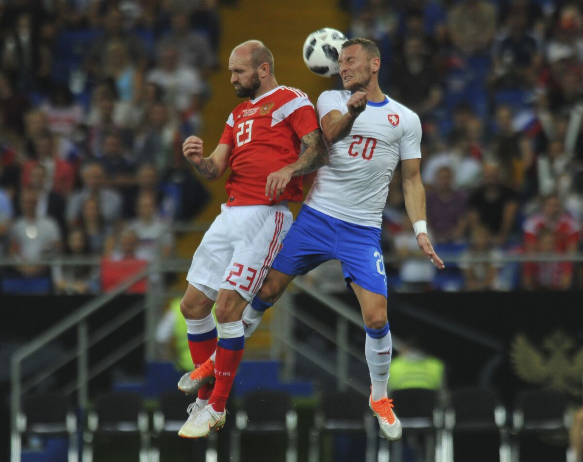 FILE - In this Monday, Sept. 10, 2018 filer, Russia's Konstantin Rausch, left, and Czech Republic's Vladimír Coufal head for the ball during a friendly soccer match between Russia and Czech Republic in the Rostov Arena, in Rostov-on-Don, Russia. (AP Photo/Sergey Pivovarov, File)