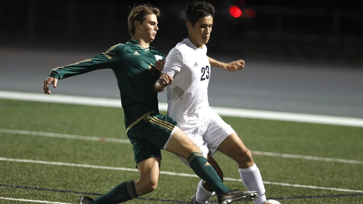 Edison's Kai Peterson, left, shown battling for possession against Newport Harbor's Tyler Beatag on Jan. 29, scored the Chargers' second goal in Saturday's 3-2 loss at San Clemente in the semifinals of the CIF Southern Section Division 1 playoffs.