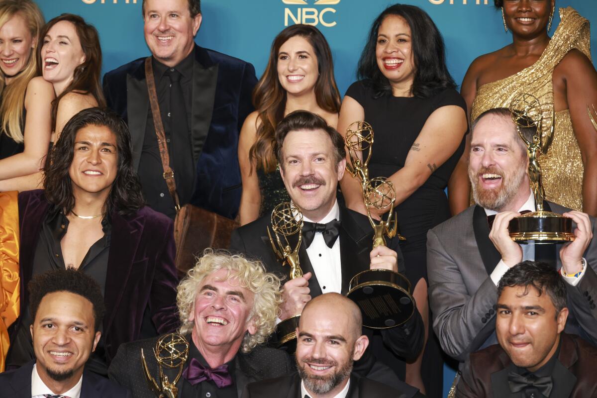 Jason Sudeikis, center and some of the cast and crew for “Ted Lasso” at this year's Emmys.