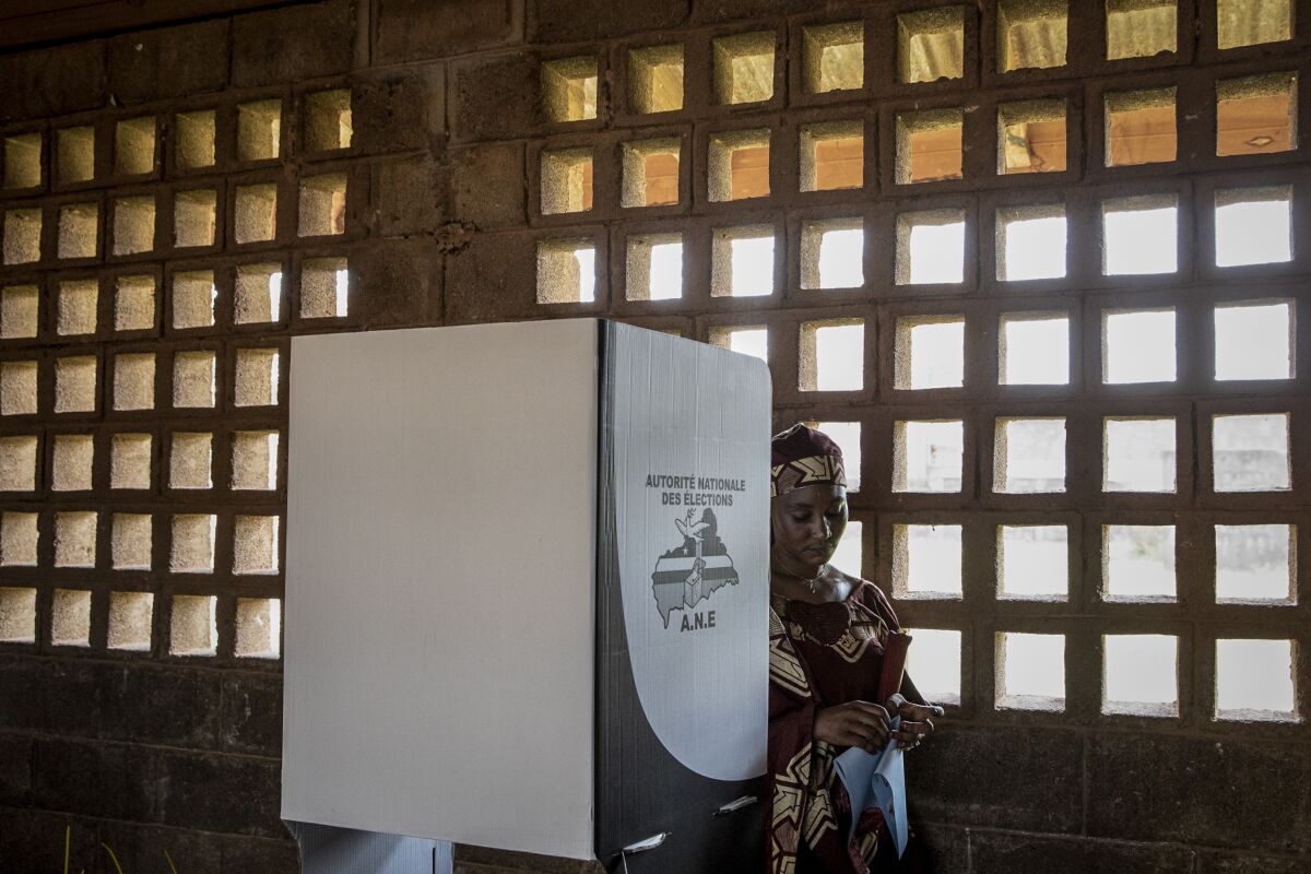 A woman casts her vote at the Koudougou school polling station in the capital Bangui, Central African Republic Sunday, Dec. 27, 2020. Voting has begun in Central African Republic's presidential and legislative elections after a campaign period marked by violence between rebels and government forces. (AP Photo)