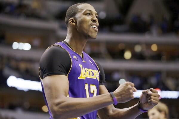 Center Dwight Howard celebrates as the Lakers close out a 103-99 victory over the Mavericks on Sunday afternoon in Dallas.