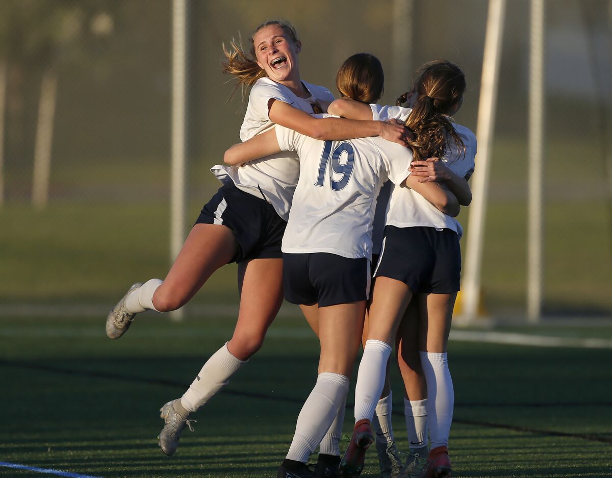Marina's Sarah Sumrall (19) is mobbed by teammates after tying the game against Corona del Mar on Wednesday.