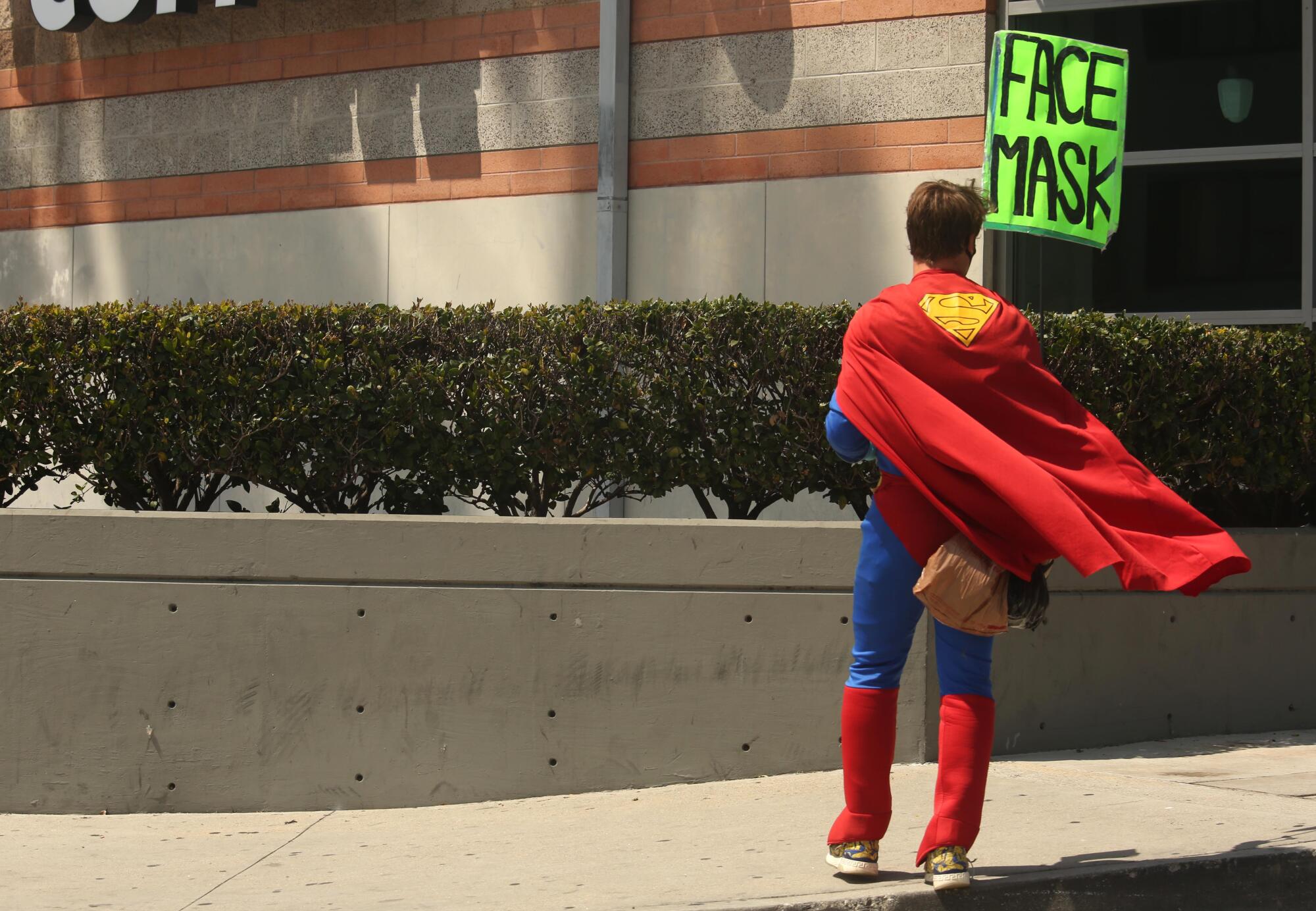 A man dressed as Superman advertises face masks in Marina del Rey.