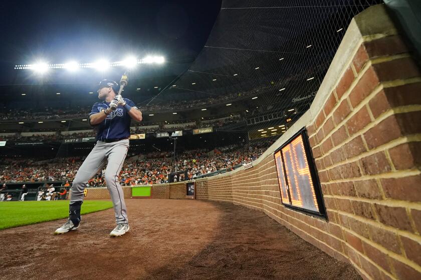 The pitch clock is seen as Tampa Bay Rays' Luke Raley stands near the on deck circle in the second inning of a baseball game against the Baltimore Orioles, Thursday, Sept. 14, 2023, in Baltimore. (AP Photo/Julio Cortez)