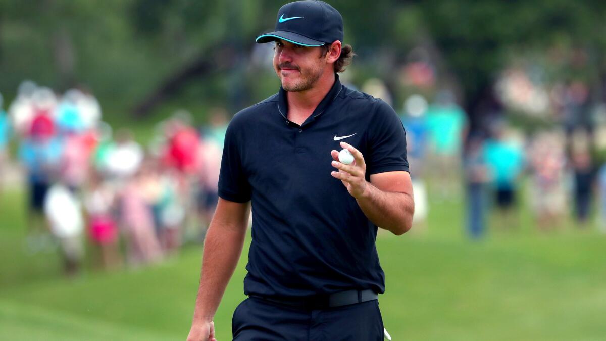 Brooks Koepka acknowledges fans after completing the 10th hole on Saturday during the third round of the AT&T Byron Nelson tournament.