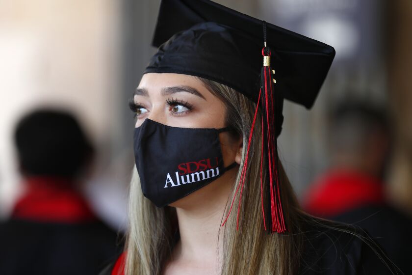 SAN DIEGO, CA - MAY 25: Amber Ramirez wears a SDSU mask as she gets ready go graduate with a degree in psychology from San Diego State University as the College of Sciences' held their ceremony at Petco Park on Tuesday, May 25, 2021 in San Diego, CA. Graduations for SDSU will take place at Petco Park through Thursday. (K.C. Alfred / The San Diego Union-Tribune)
