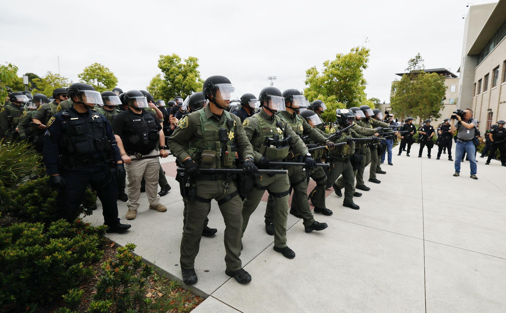     Orange County Sheriff's deputies form a containment line at UCI on May 15, 2024. 