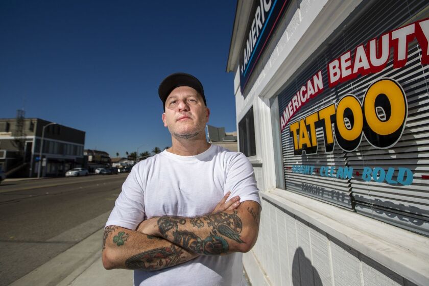 SUNSET BEACH, CALIF. -- FRIDAY, OCTOBER 19, 2018: James Real, the owner of American Beauty Tattoo in Sunset Beach, said over a period of a few years he saw more than a hundred Sheriff's deputies come into his shop to get inked with identical tattoos of a skeleton in a cowboy hat. The tattoos were done by an artist who rented a chair in his shop. Real said hed seen military members get coordinated tattoos, but it struck him as odd when the clients were local police. It paints a very strong picture of a group of law enforcement agents that are basically unifying themselves in a way that resembles a gang, he said. Photos taken in Sunset Beach, Calif., on Oct. 19, 2018. (Allen J. Schaben / Los Angeles Times)