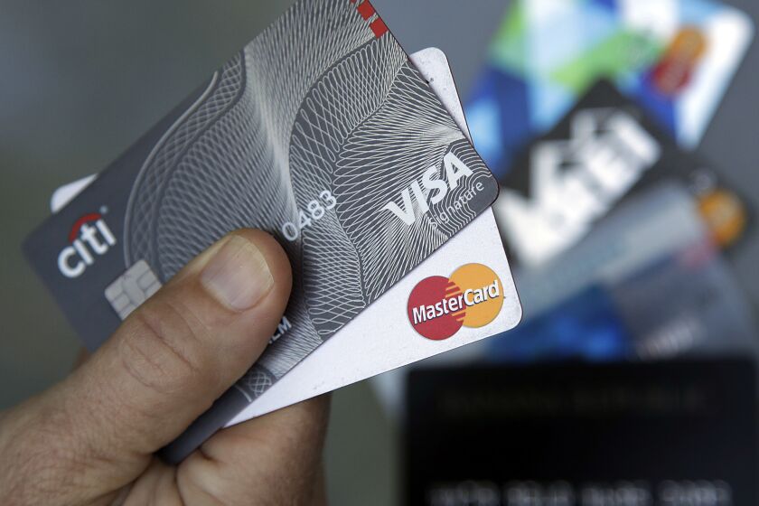 FILE- In this June 15, 2017, file photo, credit cards are displayed in Haverhill, Mass. Visa and Mastercard say they and several banks will pay $6.2 billion to settle part of a long-running lawsuit brought by merchants over fees on credit card transactions. (AP Photo/Elise Amendola, File)