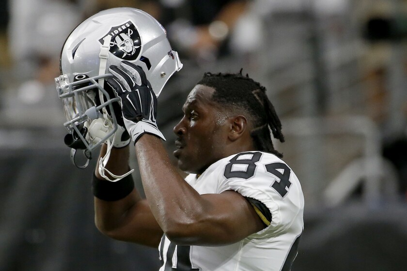 Antonio Brown puts on his helmet prior to a preseason game between the Oakland Raiders and the Arizona Cardinals, on Aug. 15 in Glendale, Ariz.