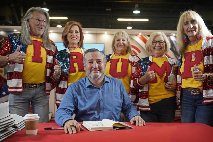 Supporters of former President Donald Trump line up behind Sen. Ted Cruz, R-Texas, to pose for photos during a book signing at the Conservative Political Action Conference (CPAC) in Dallas, on Aug. 5, 2022. (AP Photo/LM Otero)