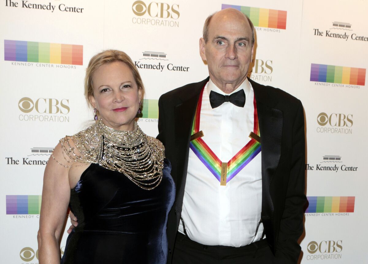 FILE - In this Dec. 4, 2016 file photo, Kim Taylor, left, and her husband James Taylor appear at the 39th Annual Kennedy Center Honors in Washington, D.C. The couple have donated $1 million to Massachusetts General Hospital in Boston to help with its battle against the spread of the new coronavirus. The gift, announced Tuesday, March 24, 2020, will help the hospital direct resources where the need is greatest, the hospital said in a statement. (Photo by Owen Sweeney/Invision/AP, File)