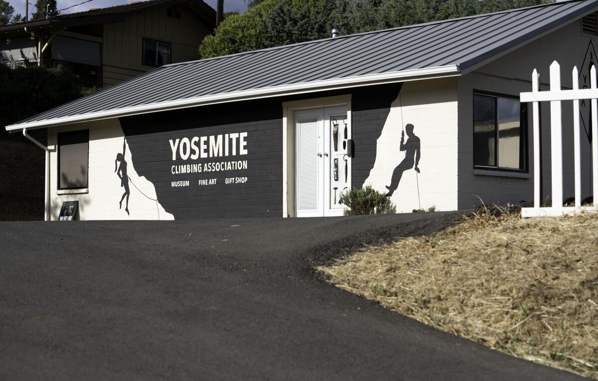 A small building with paintings of climbers on the outside