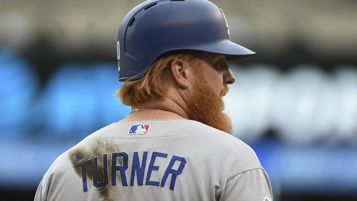 Dodgers' Justin Turner looks on from third base during the eighth inning against the Colorado Rockies on Sunday in Denver.