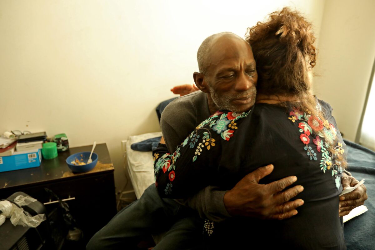 Dr. Heidi Behforouz gives a hug of support to patient Rafer Henderson, 63.