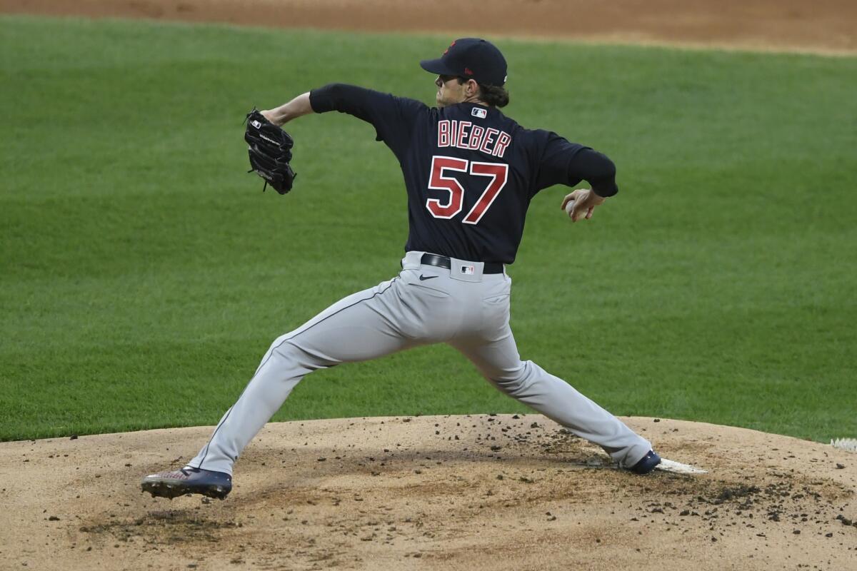 Cleveland Indians starter Shane Bieber delivers a pitch during the first inning of a baseball game against the Chicago White Sox Tuesday, April 13, 2021, in Chicago. (AP Photo/Paul Beaty)