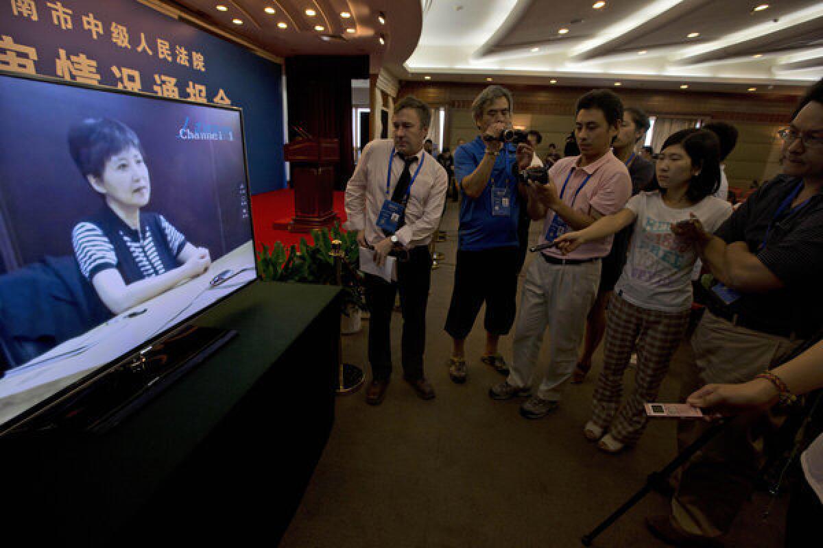 Journalists watch pre-recorded testimony by Gu Kailai, the wife of former Chinese politician Bo Xilai, in August at a hotel in Jinan, China. Many contrasted the case of vendor Xia Junfeng, who was executed Wednesday, with that of Gu, who is serving a life term.