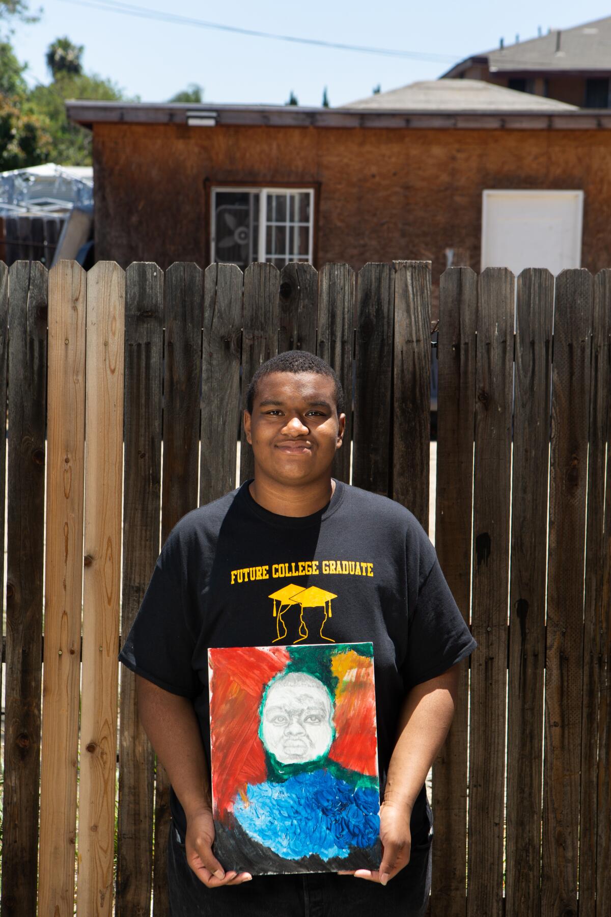 Artist Keith Wallick, 17, holds one of his works.