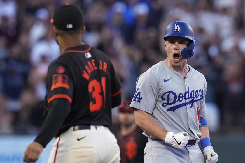 Los Angeles Dodgers' Will Smith, right, reacts after hitting a two-run double against.
