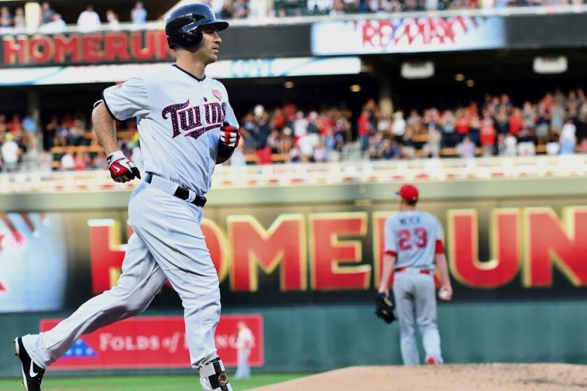 Minnesota Twins first baseman Joe Mauer jogs to home after hitting a three-run home run off Los Angeles Angels starting pitcher Alex Meyer in the second inning of a baseball game, Monday July 3, 2017, in Minneapolis. (AP Photo/John Autey)