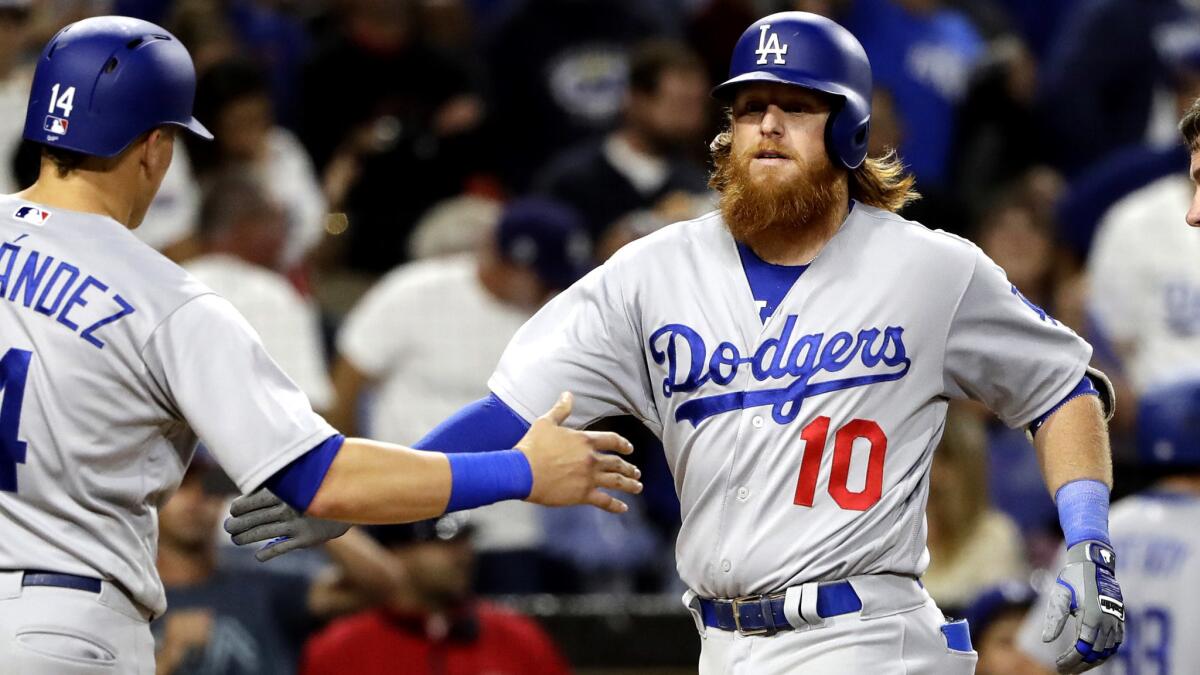 Dodgers' Justin Turner (10) is greeted by Enrique Hernandez (14) after hitting a two-run home run during the fourth inning against the San Diego Padres on June 30.