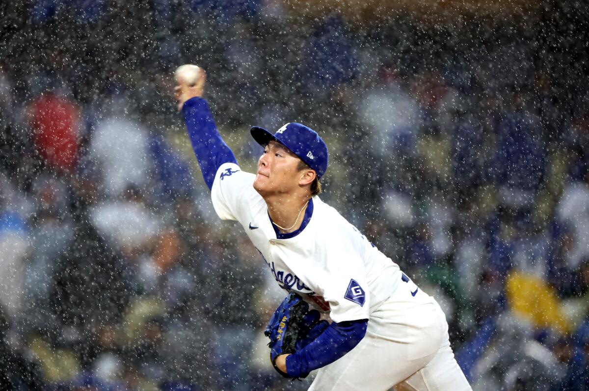 Dodgers starting pitcher Yoshinobu Yamamoto delivers during the fourth inning of a 6-5 loss to the St. Louis Cardinals.