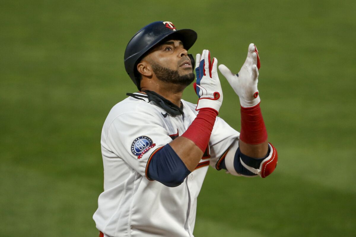 Minnesota Twins' Nelson Cruz celebrates his solo home run against the Kansas City Royals during the fourth inning of a baseball game Monday, Aug. 17, 2020, in Minneapolis. (AP Photo/Bruce Kluckhohn)