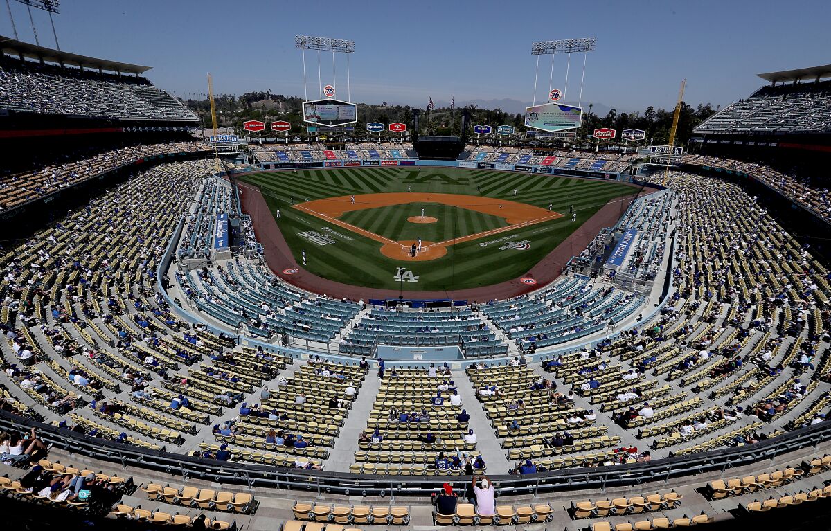 Socially distanced fans attend the Dodgers' home opener against the Washington Nationals on Friday.