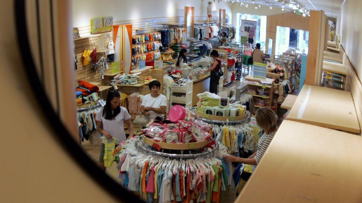 A security mirror shows shoppers at a Gymboree store in Palo Alto, Calif., in 2005.