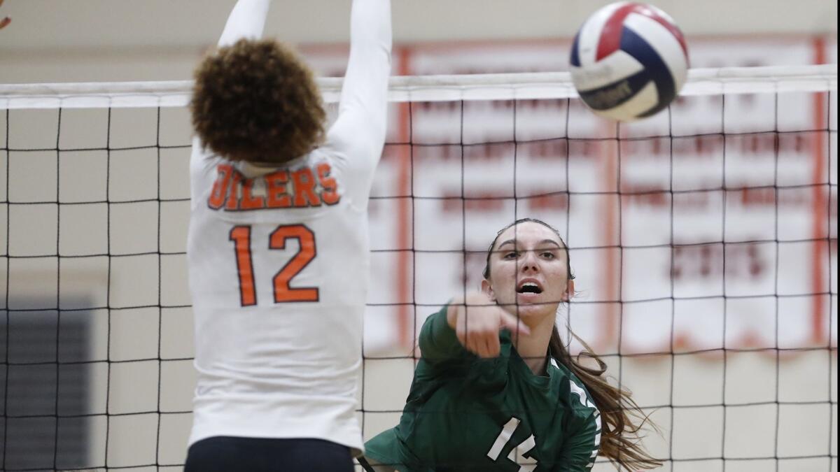 Xolani Hodel, shown trying to block a shot on Sept. 26, 2017, finished with 15 kills in Huntington Beach High's 25-23, 23-25, 25-10, 25-20 nonleague win over Los Angeles Marlborough on Tuesday.