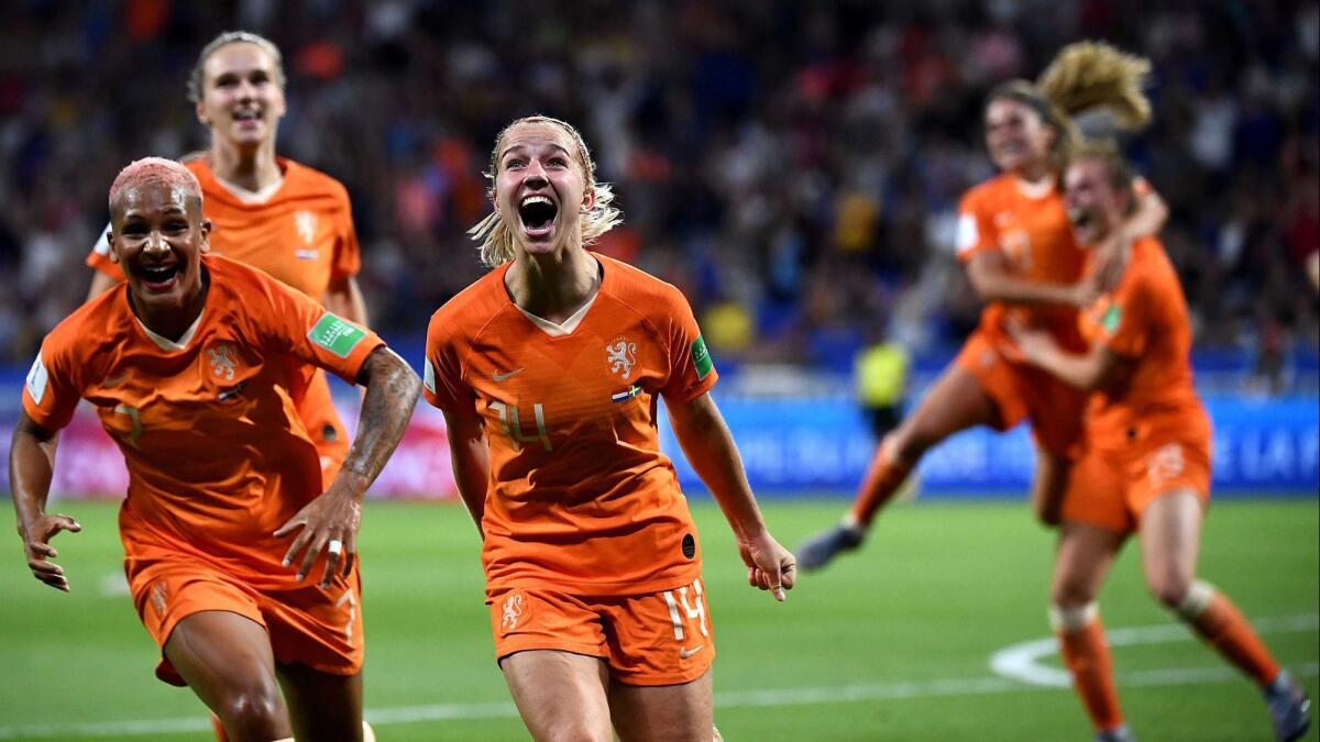 Netherlands midfielder Jackie Groenen, middle, is congratulated by teammates after scoring a goal against Sweden during the World Cup semifinals.