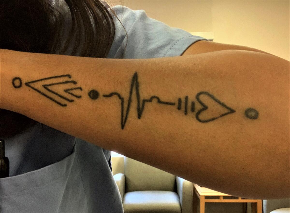 Nurse Tiffany Hughes and co-workers got tattoos representing their unit's nickname, "tip of the spear."