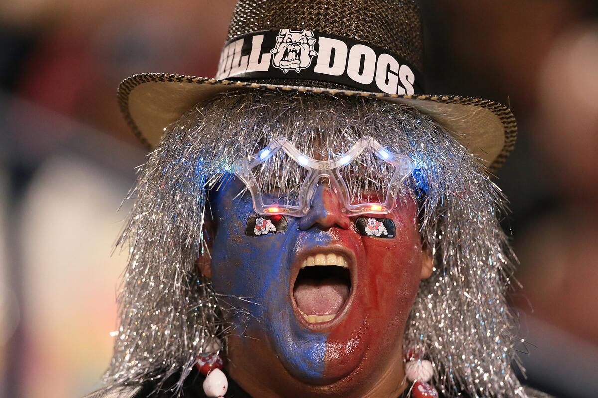 Flamboyant fan Johnny Hernandez cheers the Fresno State football team during the Bulldogs' recent 45-23 rout of Nevada.