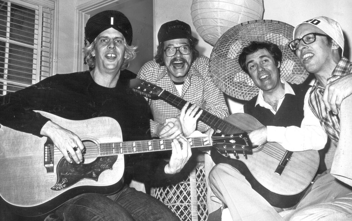 Phil Austin, left, who was a founding member of Firesign Theatre, seen Feb. 21, 1980, with David Ossman, Philip Proctor and Peter Bergman, has died at 74.