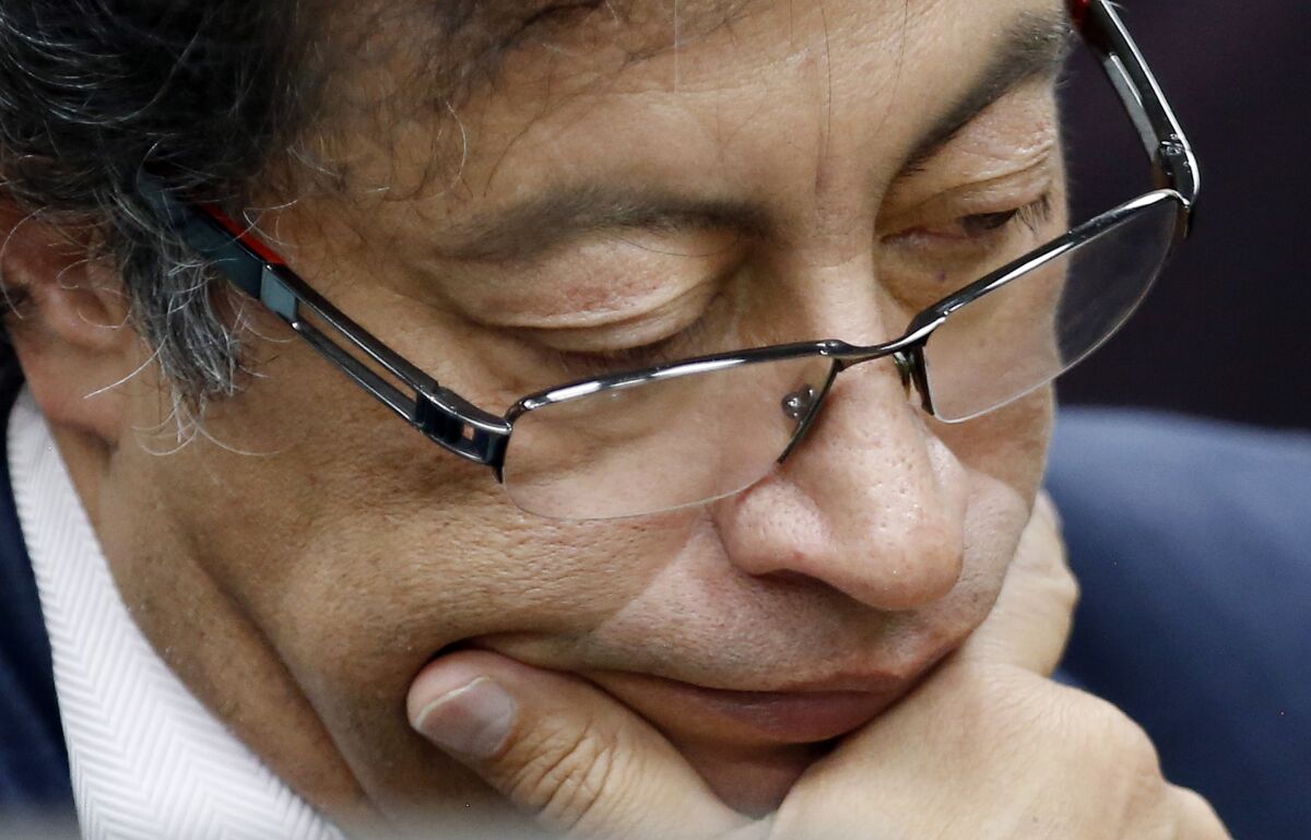 FILE - In this Dec. 4, 2018 file photo, Senator Gustavo Petro pauses during an interview at a local radio station in Bogota, Colombia. The former presidential candidate has adopted a low-key approach during the anti-government protests that started in late April 2021 ahead of his third run for Colombia’s presidency. AP Photo/Fernando Vergara, File)