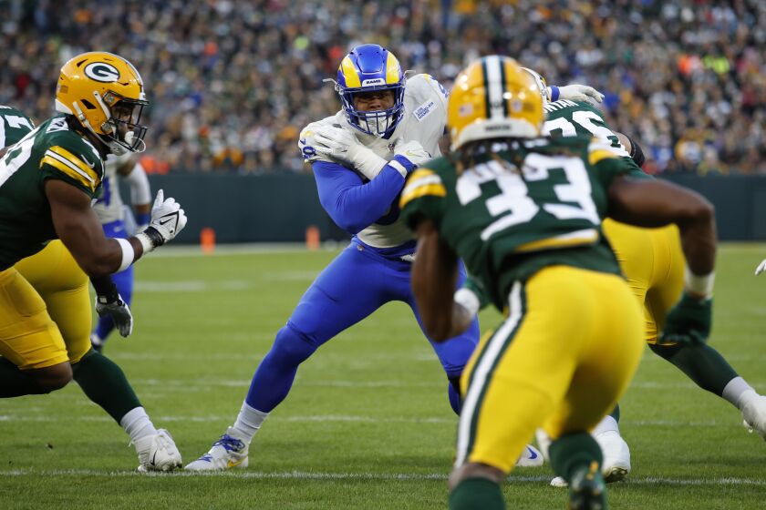 Los Angeles Rams defensive end Aaron Donald (99) rushes in against the Green Bay Packers during an NFL football game Sunday, Nov. 28, 2021, in Green Bay, Wis. The Packers defeated the Rams 36-28. (Jeff Haynes/AP Images for Panini)