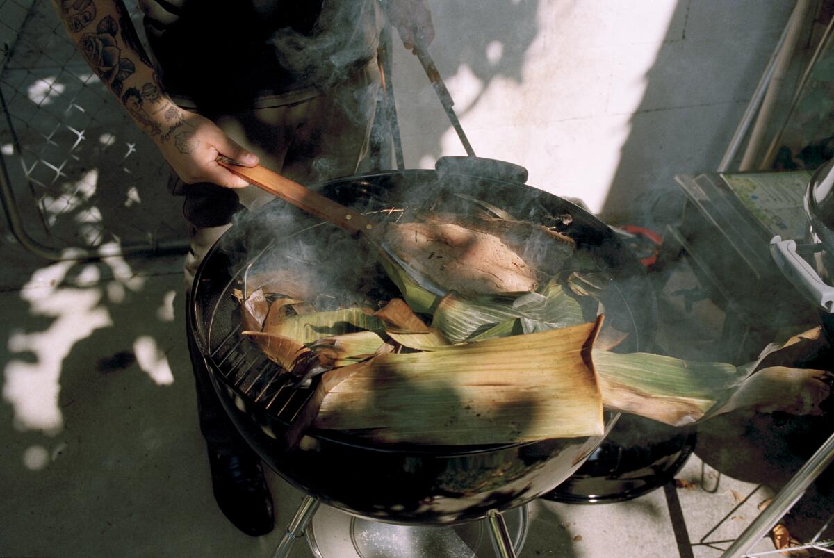 Chef Kris Yenbamroong from Night + Market steams carp in banana leaves.