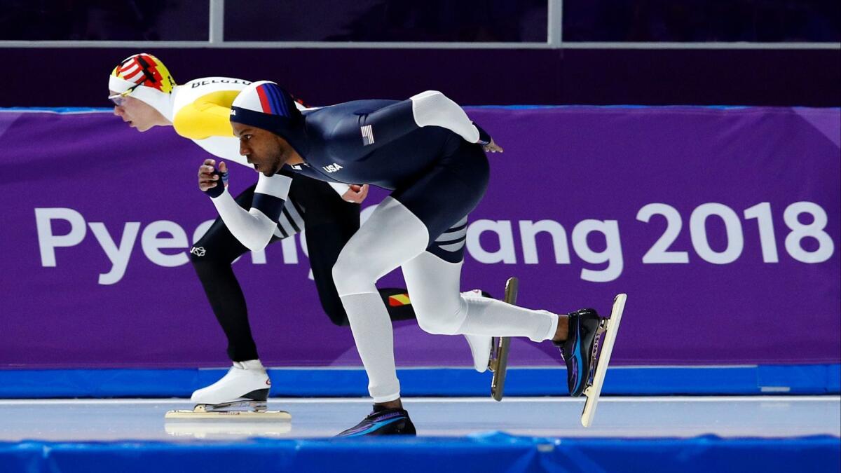 Shani Davis of the U.S., right, and Bart Swings of Belgium, left, compete during the men's 1,500 meters speedskating race at the 2018 Winter Olympics in Gangneung, South Korea on Feb. 13, 2018.