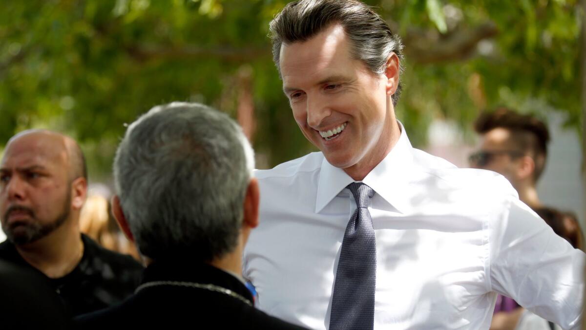 Lt. Gov. Gavin Newsom speaks with participants in an Armenian march in Los Angeles on April 24.