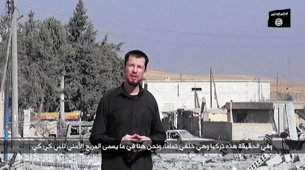 In an image taken from video, Islamic State hostage John Cantlie, a British photojournalist, delivers a "news report" on the situation in Kobani, Syria.