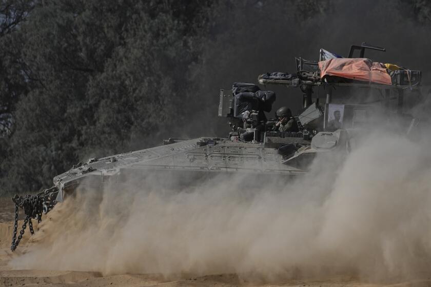 An Israeli military armored personnel carrier maneuvers near the Israel-Gaza border in southern Israel, Wednesday, June 12, 2024. (AP Photo/Tsafrir Abayov)