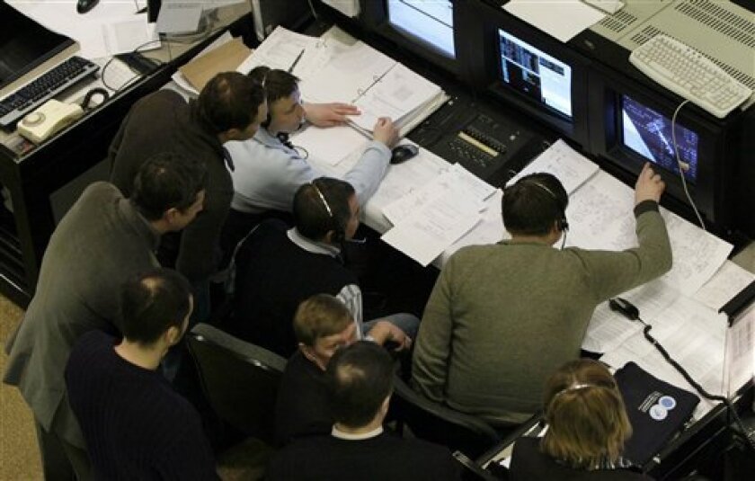 Specialists are busy at Russia's mission control center in Korolyov, outside Moscow, as Soyuz capsule carrying a Russian cosmonaut, an American astronaut and U.S. billionaire tourist Charles Simonyi docks at the international space station Saturday, March 28, 2009. (AP Photo/Misha Japaridze)