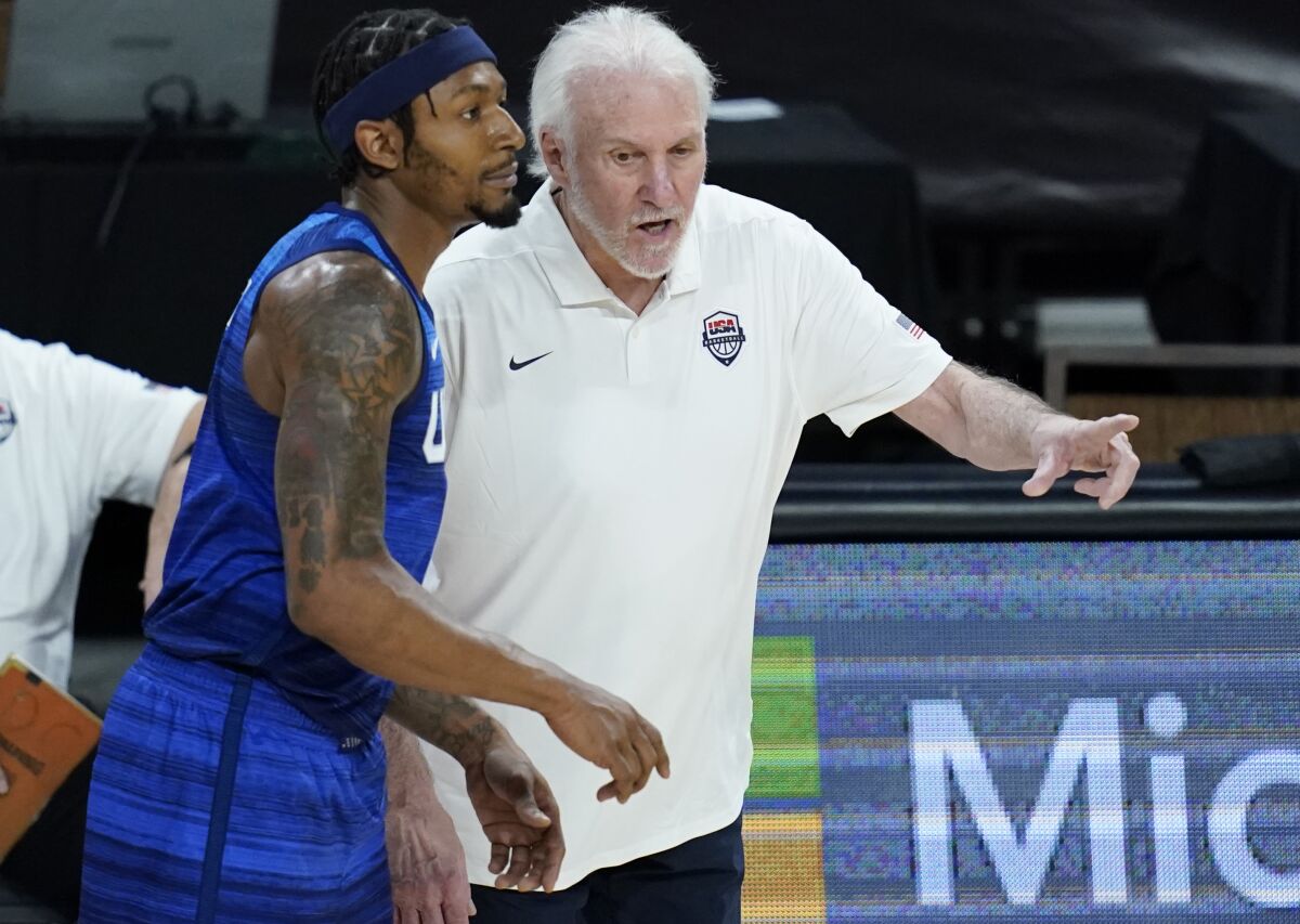 United States' head coach Gregg Popovich speaks with Bradley Beal.