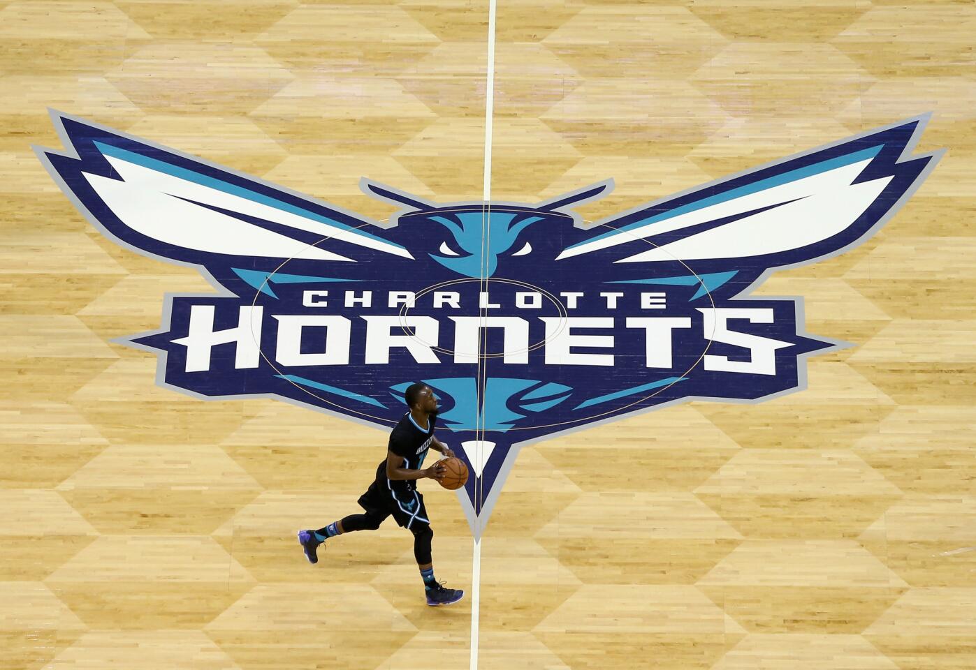 Hornets guard Kemba Walker brings the ball up the court during a game against the Lakers.