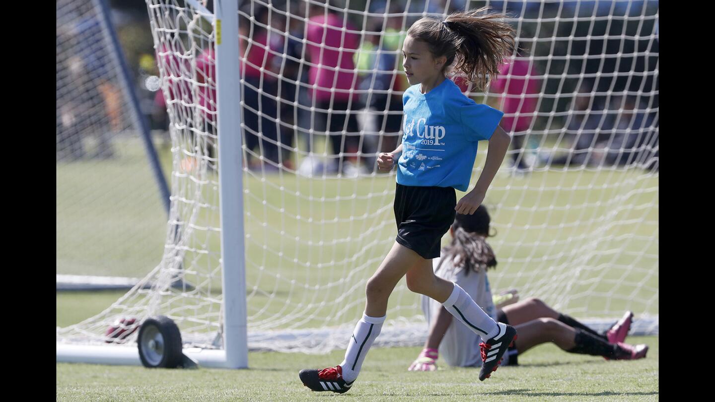 Costa Mesa Victoria Elementary's Adrianna Ramirez jogs back after kicking the ball into the left corner of the net against Costa Mesa Whittier in a girls’ third- and fourth-grade Silver Division pool-play match at the Daily Pilot Cup on Thursday at Jack R. Hammett Sports Complex in Costa Mesa.