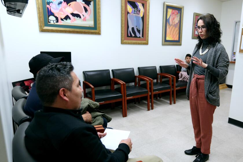 Consul general Ivonne Guzman, the first woman in the history of Consulate of Ecuador in Los Angeles, interacts with customers Elias Muoz of Chicago and Mario Muoz of Las Vegas, at her Wilshire Blvd. office on Wednesday Dec. 4, 2019. Guzman, who has been leading the office in Los Angeles for one year, is in her first consular mission as a political appointee.