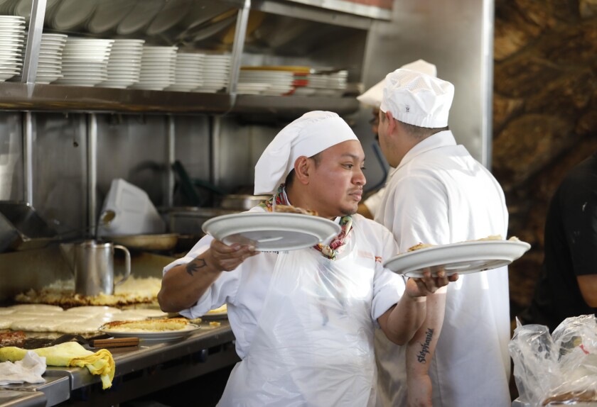 Cooks prepare orders at Norms