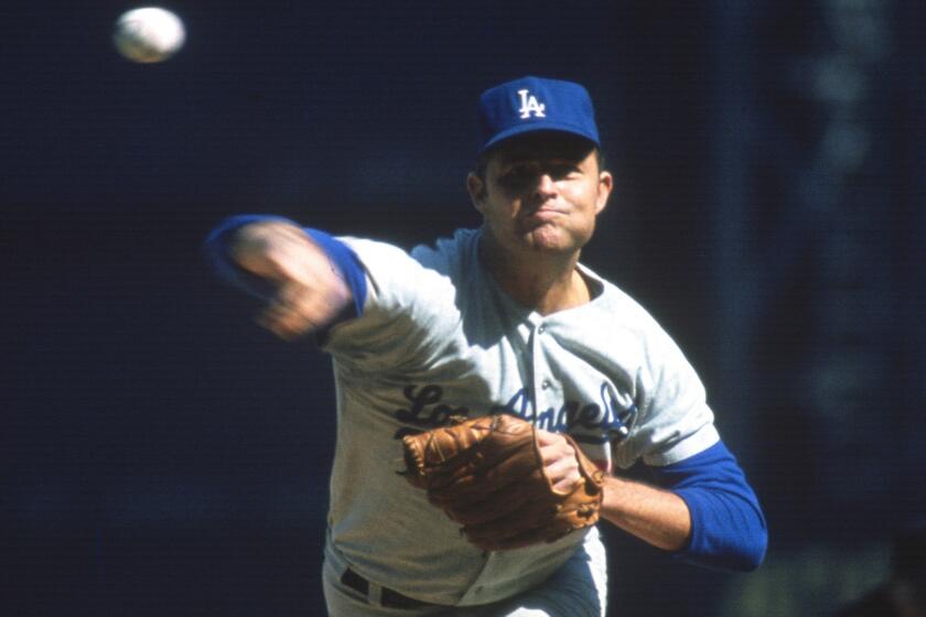 Dodgers pitching great Don Drysdale delivers a pitch during a game against the Pittsburgh Pirates in 1965.